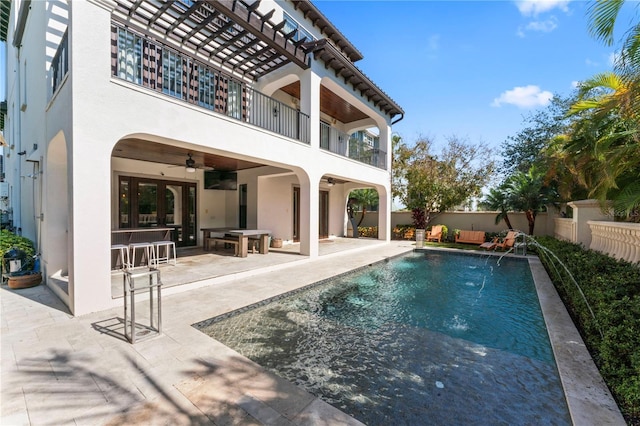 view of swimming pool with a ceiling fan, a fenced in pool, a fenced backyard, and a patio