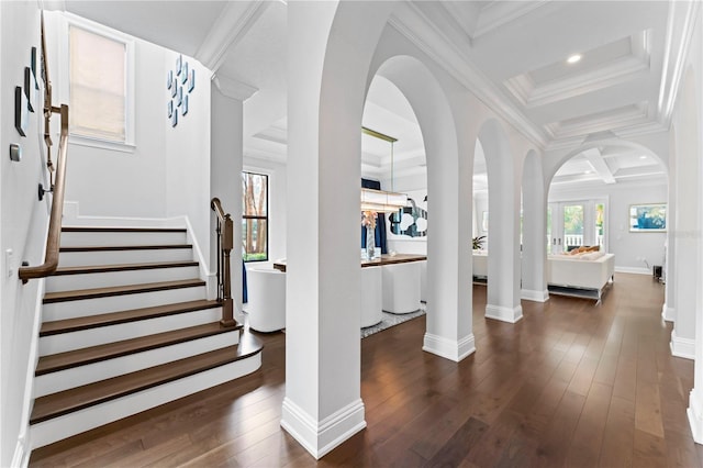 foyer entrance featuring baseboards, wood-type flooring, ornamental molding, stairs, and recessed lighting