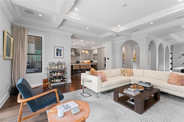 living room with recessed lighting, coffered ceiling, arched walkways, and wood finished floors