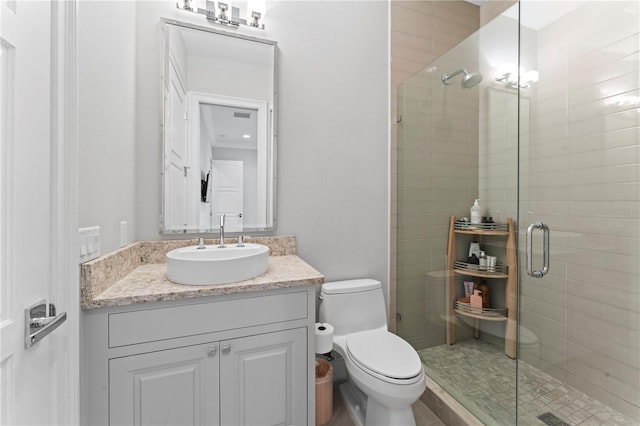 bathroom featuring visible vents, a stall shower, vanity, and toilet