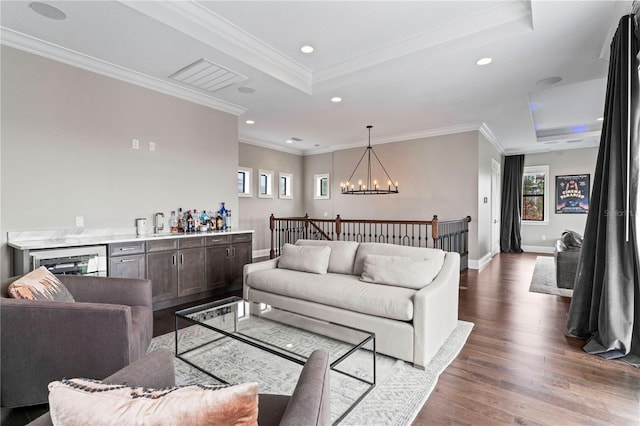 living room with dark wood-style floors, recessed lighting, a raised ceiling, visible vents, and an inviting chandelier