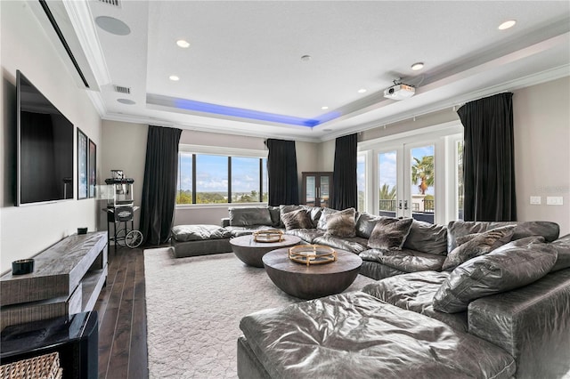 living area featuring dark wood-style floors, a tray ceiling, crown molding, and french doors