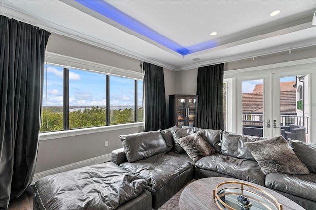 bedroom with baseboards, access to outside, a tray ceiling, french doors, and recessed lighting