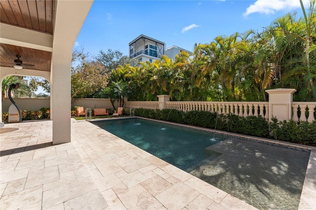 view of swimming pool featuring fence private yard, a fenced in pool, a ceiling fan, and a patio