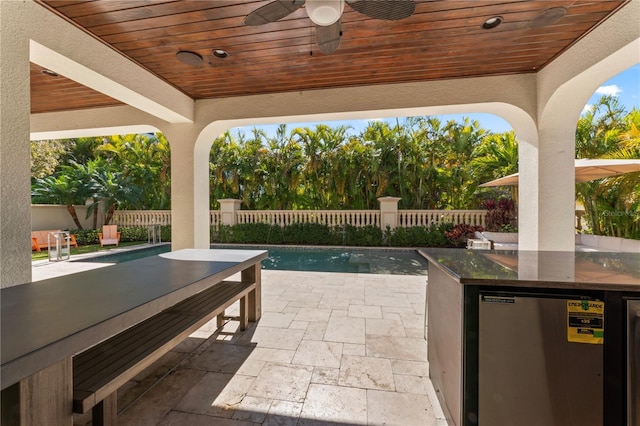 view of patio with ceiling fan, outdoor dining area, and a fenced backyard