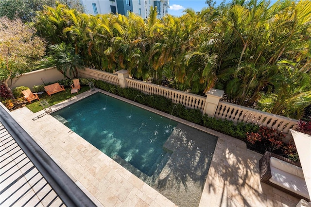 view of pool with a fenced backyard