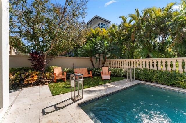 pool featuring a patio area and fence