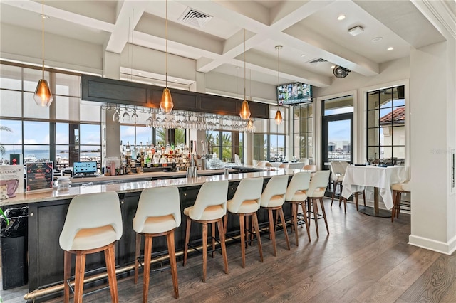 bar featuring coffered ceiling, visible vents, dark wood finished floors, and beamed ceiling