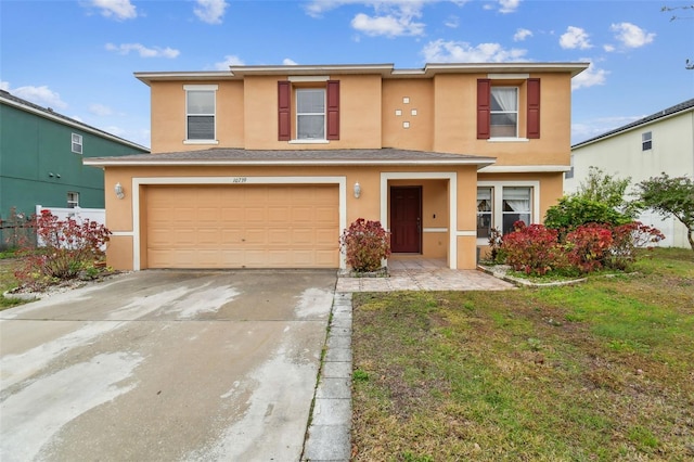 view of property with a garage and a front lawn