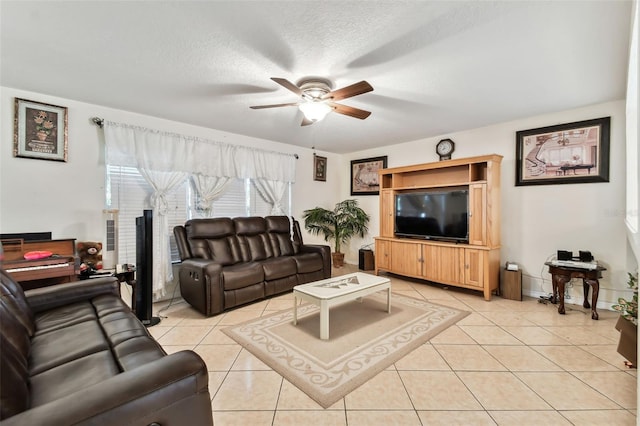 living room with light tile patterned floors, a textured ceiling, and ceiling fan