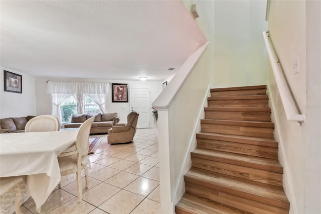 stairs with tile patterned floors