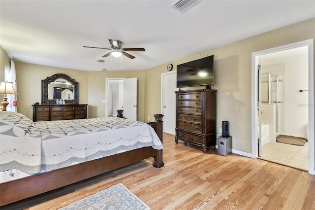 bedroom featuring hardwood / wood-style flooring, ceiling fan, and connected bathroom