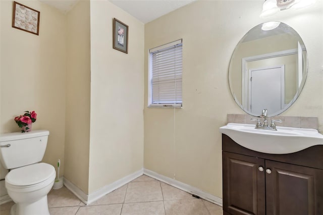 bathroom with tile patterned floors, vanity, and toilet