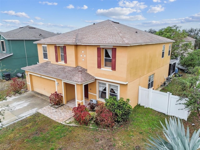 view of front of property with a garage and a front lawn