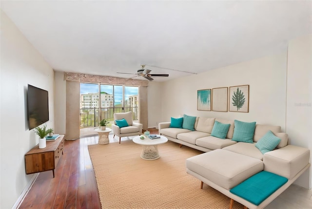 living room featuring ceiling fan and wood-type flooring