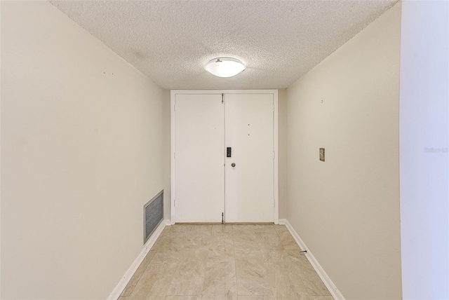 corridor with a textured ceiling