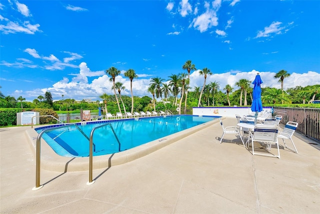 view of swimming pool with a patio