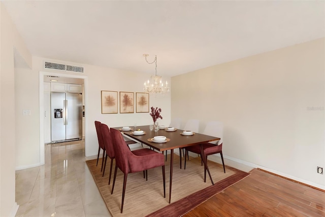 dining room featuring a chandelier and light hardwood / wood-style floors