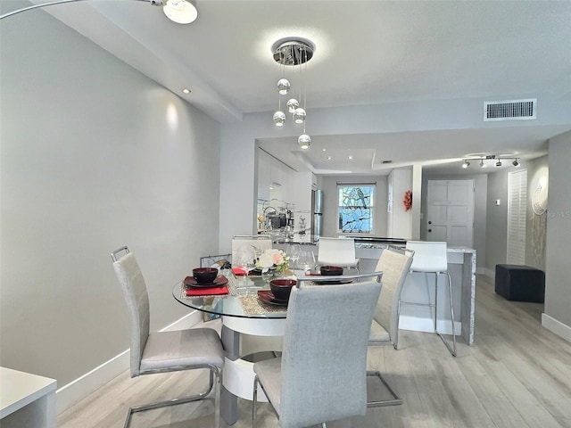 dining space with light hardwood / wood-style flooring