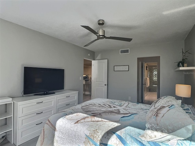 bedroom featuring ceiling fan and ensuite bath