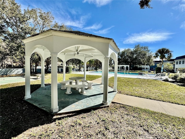 view of community featuring a gazebo, a pool, and a yard