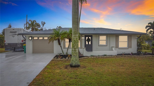 view of front of house with a yard and a garage