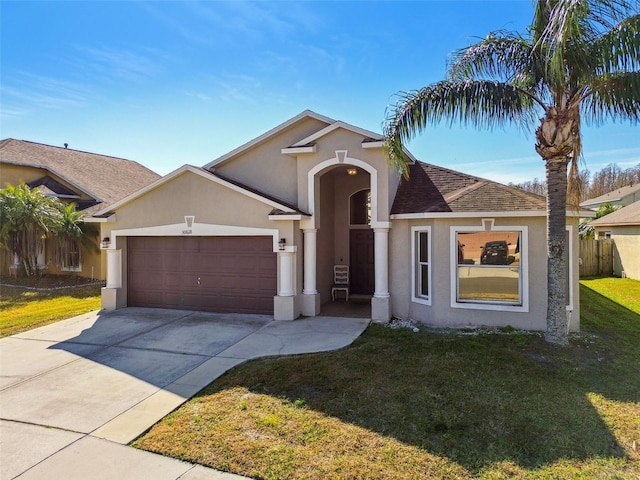 view of front facade with a garage and a front yard