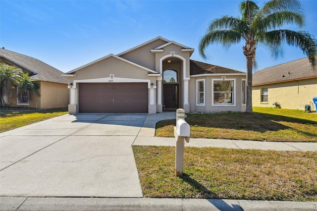 single story home featuring a garage and a front yard