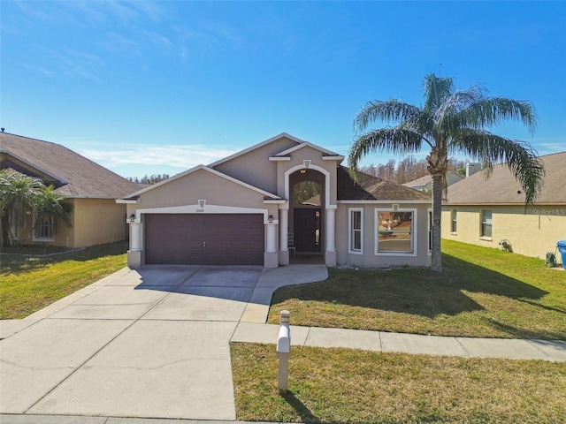 single story home with a garage and a front lawn