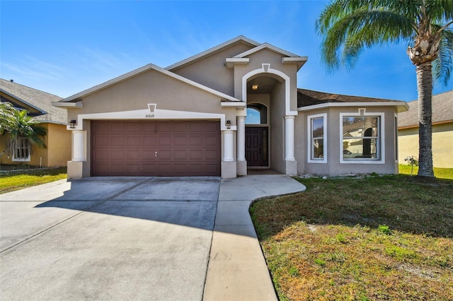 view of front of property with a garage and a front lawn