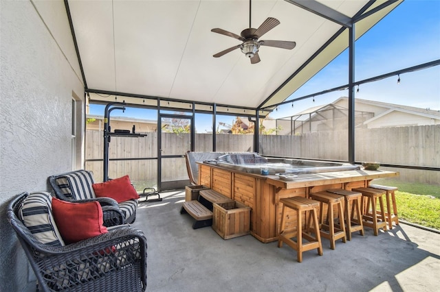 sunroom featuring lofted ceiling, plenty of natural light, and ceiling fan