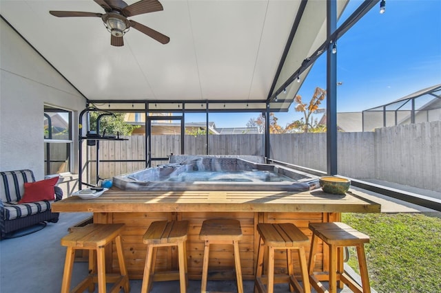 sunroom / solarium featuring ceiling fan and lofted ceiling