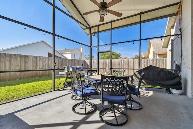 sunroom with lofted ceiling and ceiling fan