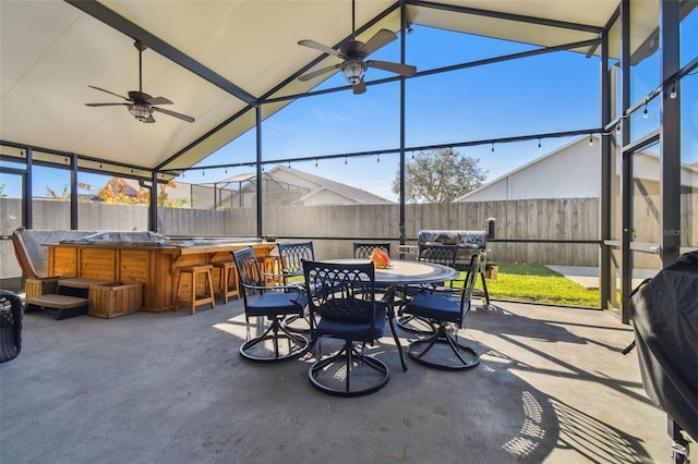 view of patio featuring a bar and ceiling fan