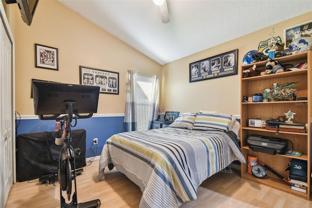 bedroom with lofted ceiling, light hardwood / wood-style flooring, and ceiling fan