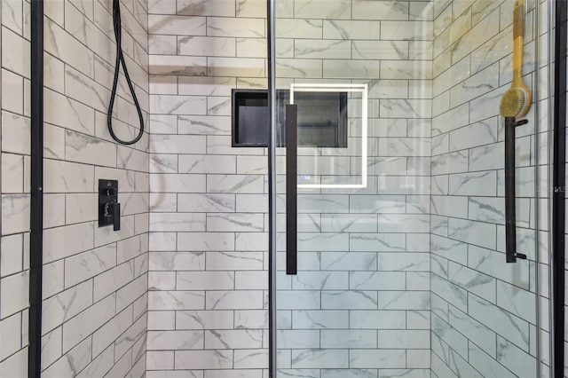 bathroom featuring a shower with door