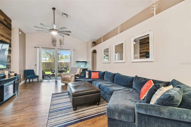 living room with lofted ceiling, hardwood / wood-style flooring, and ceiling fan