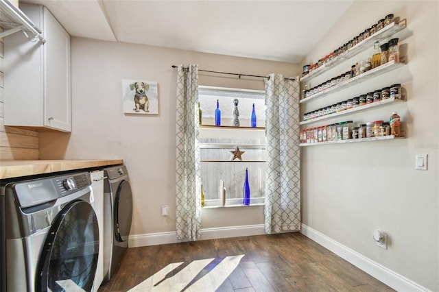 laundry room with separate washer and dryer, cabinets, and dark hardwood / wood-style floors