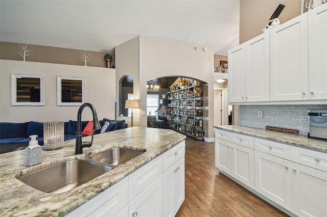 kitchen with sink, dark hardwood / wood-style floors, and white cabinets