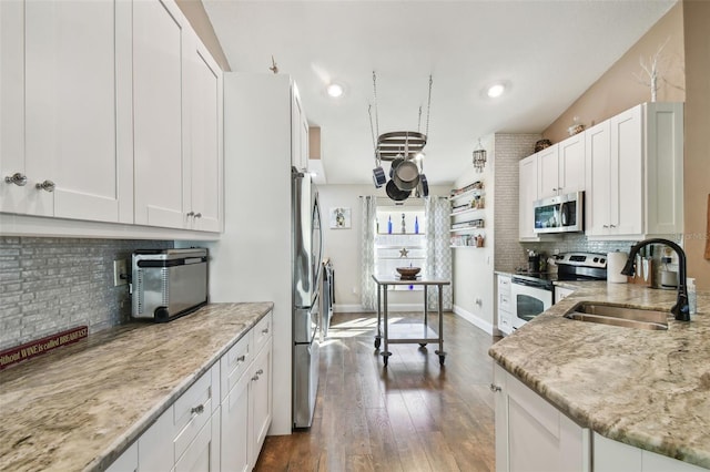 kitchen featuring white cabinetry, sink, dark hardwood / wood-style flooring, stainless steel appliances, and light stone countertops