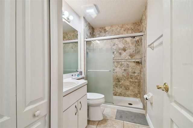 bathroom with tile patterned flooring, an enclosed shower, vanity, a textured ceiling, and toilet