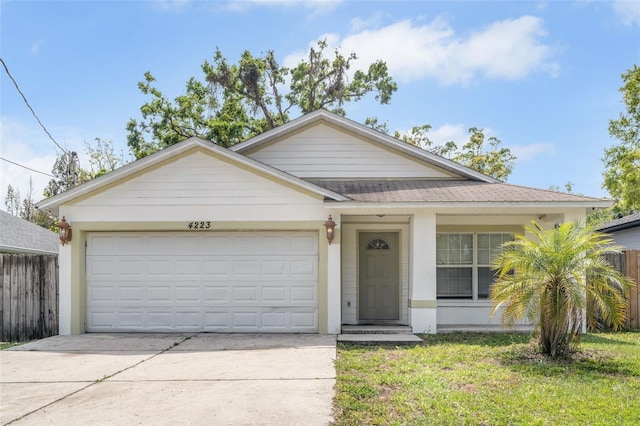 ranch-style house with a front lawn, fence, concrete driveway, roof with shingles, and an attached garage