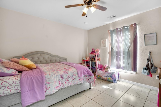 tiled bedroom with visible vents, multiple windows, baseboards, and a ceiling fan