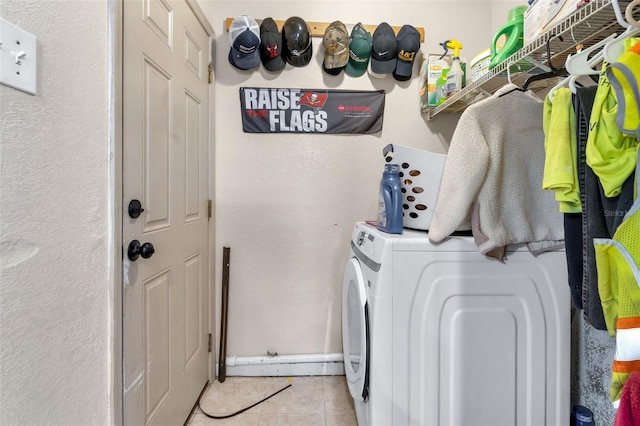 laundry room featuring light tile patterned floors, laundry area, and washer and dryer