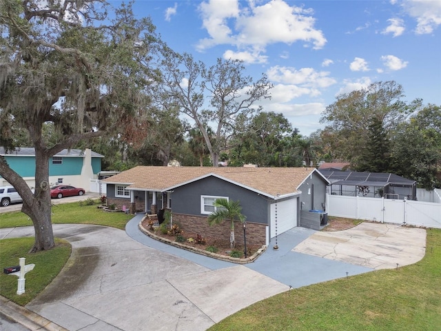 ranch-style home featuring a garage, central AC, and a front yard