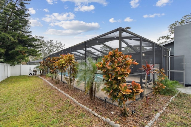 view of yard with a patio, a fenced in pool, and glass enclosure