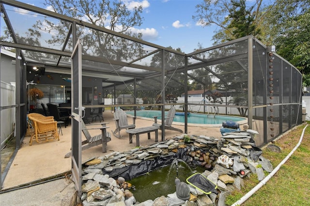 view of swimming pool with a lanai and a patio