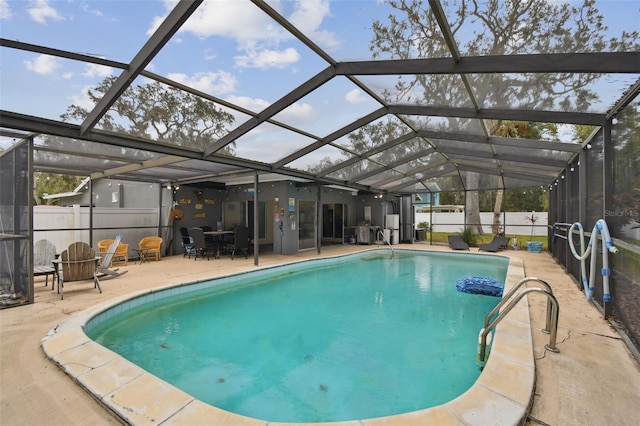 view of swimming pool featuring a lanai and a patio area