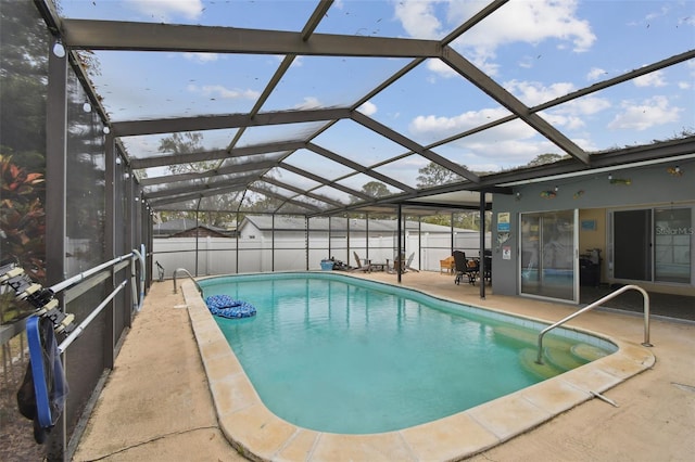 view of swimming pool with a lanai and a patio area