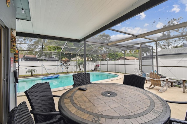 view of swimming pool with a lanai and a patio